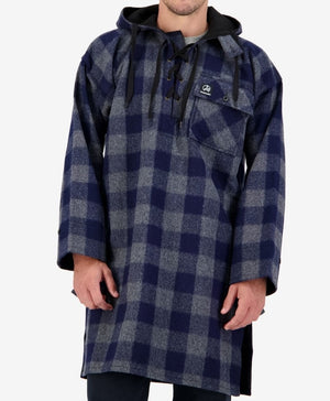 A person wearing the Swanndri Original Lace Front Bush Shirt, a blue and gray plaid hooded overcoat made from 100% wool, with black drawstrings. The coat features a large front pocket on the left chest and extends to mid-thigh. The individual has their hands relaxed by their sides against a plain white background.