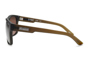 Side view of Liive Sync sunglasses with brown lenses and a sleek black/brown polycarbonate frame. They feature UV protection, branded "Sync" and "LINTIC" on the temple arm, along with the model number and CE marking for optical clarity.