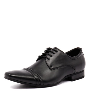 The UNcut Bartell Shoe is a black formal men's dress shoe with a polished leather finish and lace-up closure. This elegant shoe features a pointed toe, detailed stitching on the toe cap and sides, a low heel, and a slightly angled sole. It is available in UK sizing.