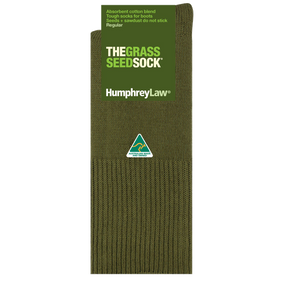 A single khaki-colored sock is displayed, labeled "Humphrey Law Grass Seed Sock - Short." Made in Australia, the packaging notes it is crafted from an absorbent cotton blend and designed as a durable boot sock that prevents seeds and sawdust from sticking.