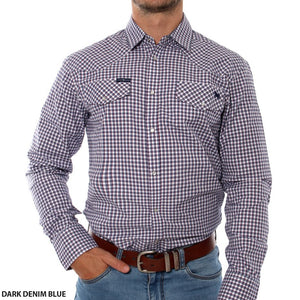 A person wearing a Ringers Western Wyoming Shirt, which is a dark denim blue checkered long-sleeve shirt featuring a collar and two breast pockets. The semi-fitted shirt, made from 100% cotton, is tucked into light blue jeans secured by a brown leather belt. The person's right hand rests in their jeans pocket. "Ringers Western" text is visible at the bottom left of the shirt.