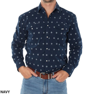 A person is wearing a navy blue, long-sleeved Ringers Western Wyoming Shirt featuring a white geometric pattern and paired with blue jeans. This semi-fitted shirt, made from 100% cotton, includes two chest pockets. The person has their hands in their jean pockets, with "NAVY" written at the bottom left corner of the shirt.