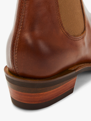 Close-up of the heel and side of a brown RM Williams Lady Yearling Rubber Sole Boot, featuring visible stitching, a layered wooden-look heel for added height, and an elastic panel for easy slip-on.