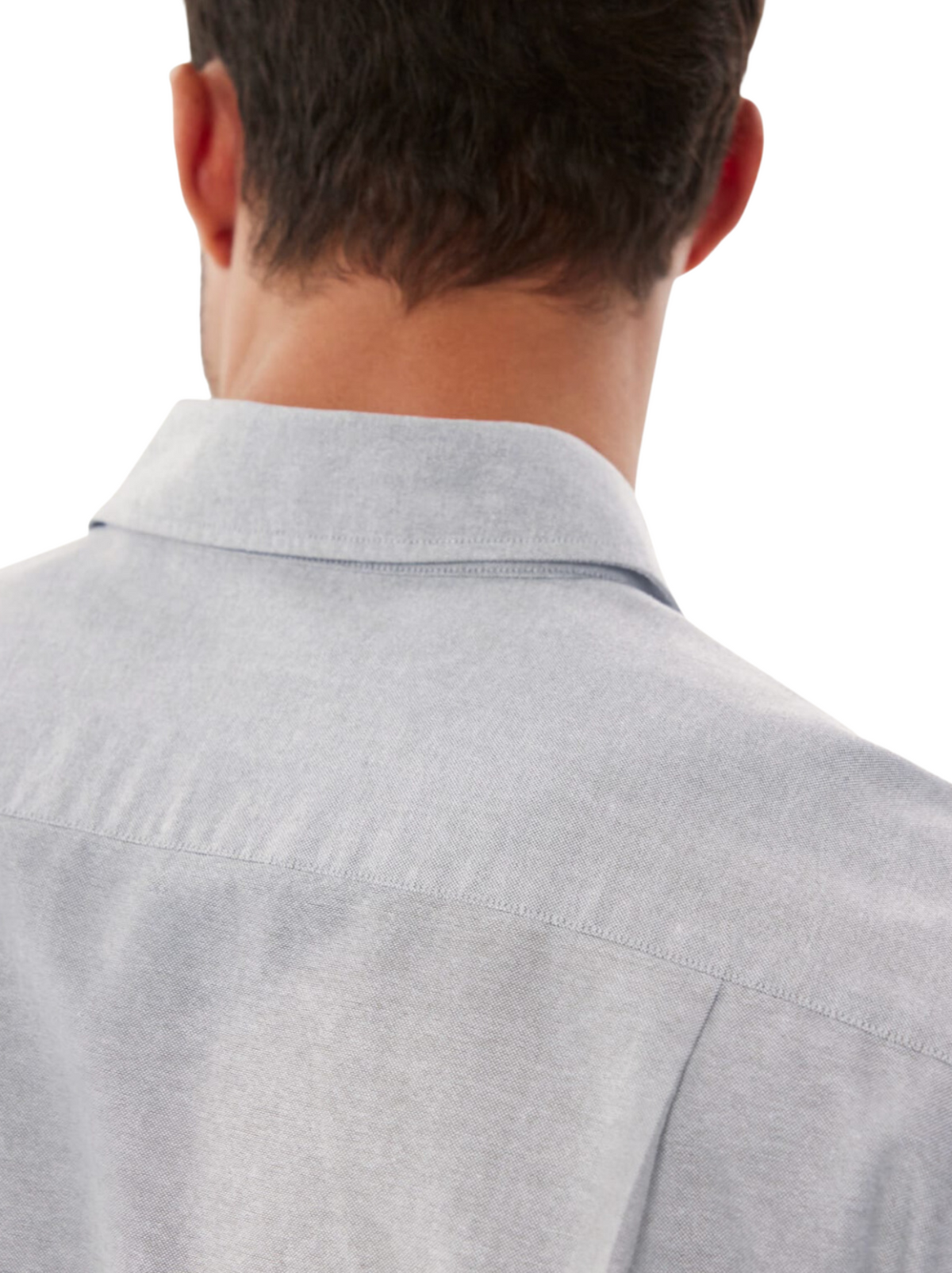 A close-up of the back of a person wearing a light gray RM Williams Collins Shirt, made from cotton paper poplin, highlighting the collar, shoulders, and upper back as the person faces away from the camera.