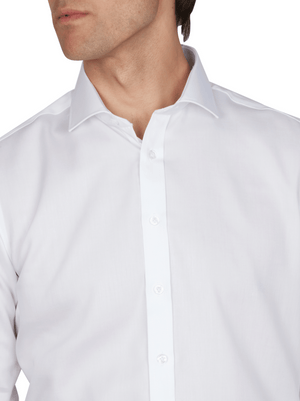 A person wears an Abelard Non Iron Cotton Twill Slim Fit Shirt in white with a classic cutaway collar; their face is partially cropped, highlighting the upper torso and shirt details.