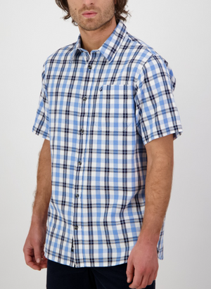 A man with medium-length brown hair, face partially visible, wears a relaxed fit Swanndri Russell Shirt in blue and white plaid (100% cotton, front pocket), standing against a plain white background.
