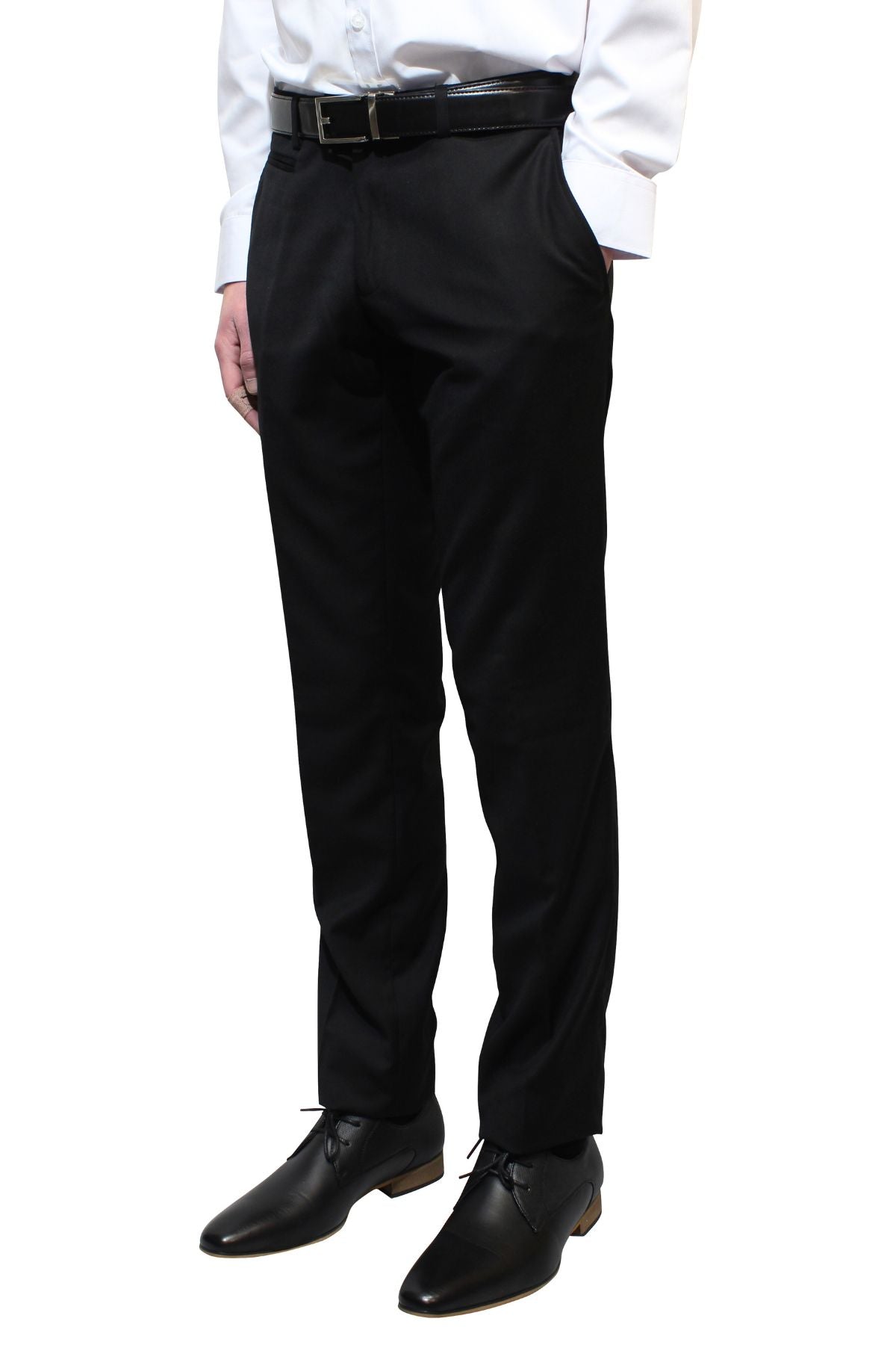 A person wearing a white shirt, black dress pants, and black dress shoes stands with hands in pockets. The image focuses on the lower half of the person's body, showcasing a classic look with slim fit Bruton Jesse Trousers.