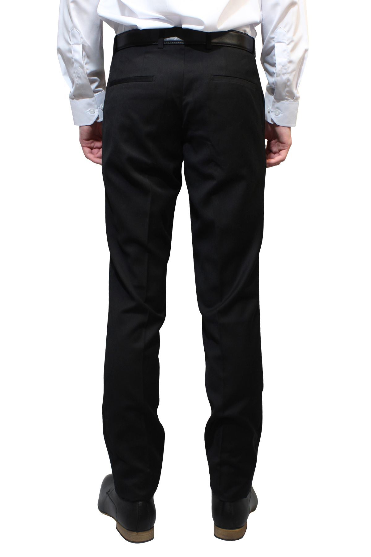 A person wearing a white dress shirt, black belt, Bruton Jesse Trouser, and black shoes stands facing away from the camera. The background is plain white. The image focuses on the slim fit lower back and legs of the Bruton Jesse Trouser outfit.