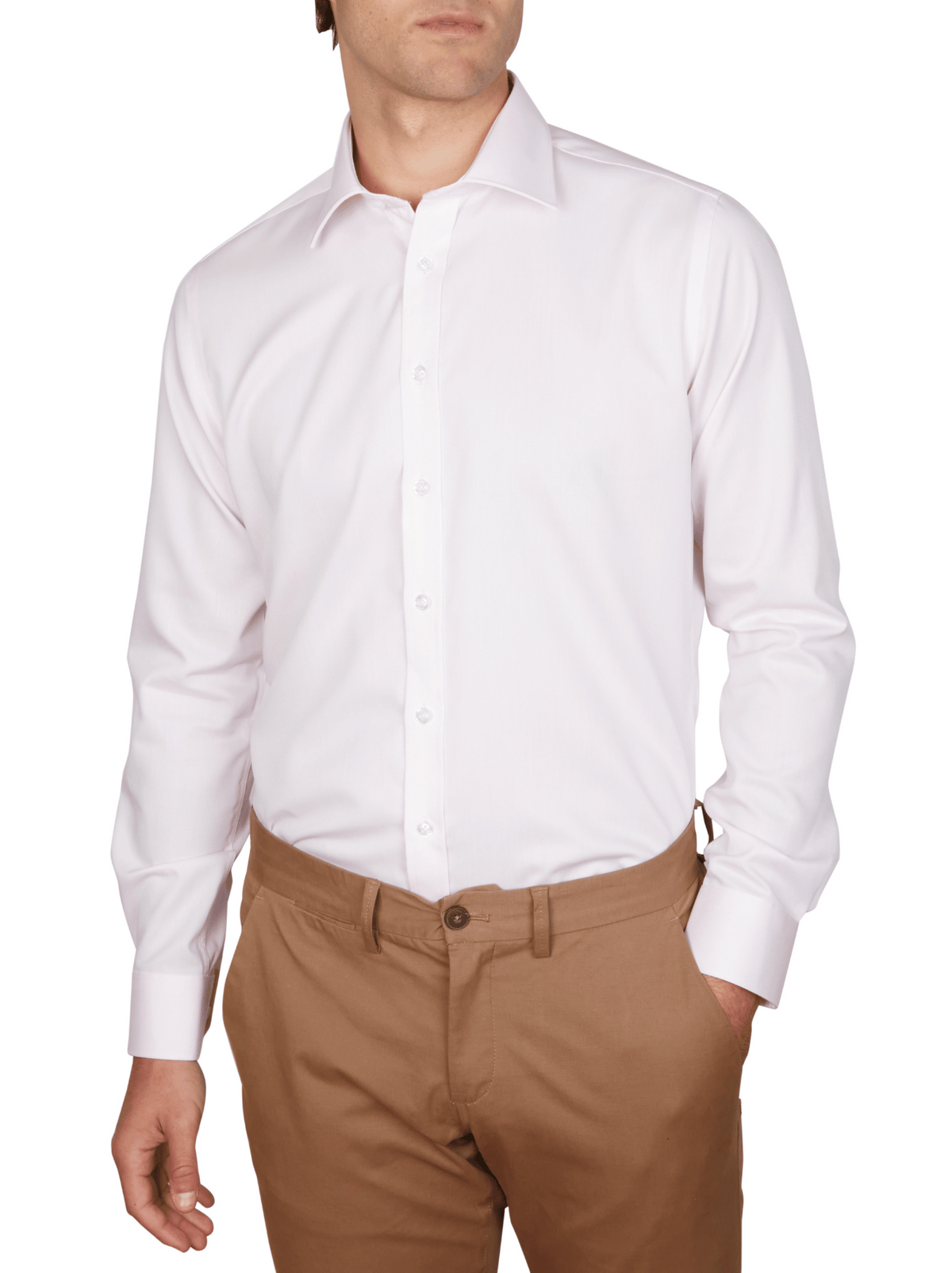 A man wearing the Abelard Non Iron Cotton Twill Slim Fit Shirt in light pink, sleeves down, paired with light brown pants and standing with one hand in his pocket against a white background.