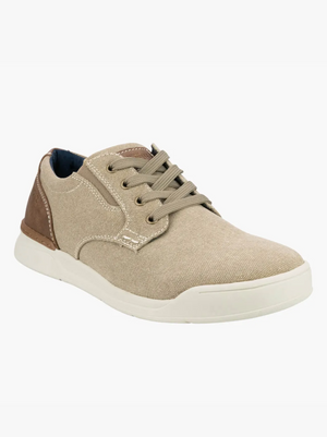 The Florsheim Kore Tour Canvas Lace Sneaker is a beige casual shoe with a white sole, brown accents on the heel and tongue, beige laces, and visible stitching. It provides all-day comfort with its lightweight design and is displayed against a plain white background.