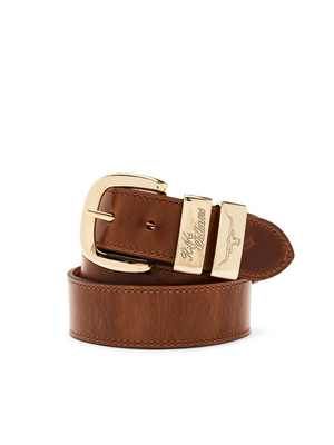 The RM Williams Drover Belt is a brown leather belt with a gold buckle featuring a stylized bull design and engraved text. Made in Australia, it showcases its smooth, polished pull-up leather texture in a neat coil.