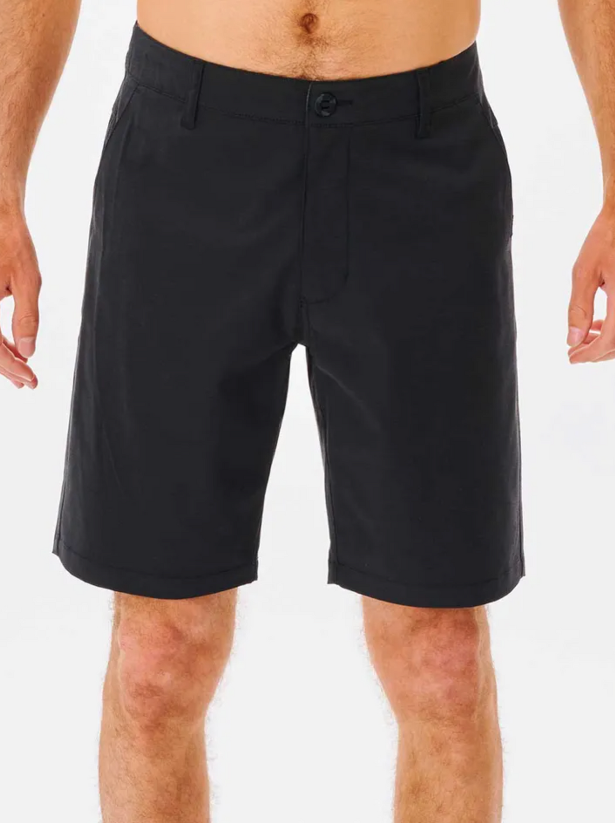 A man wears black Rip Curl Boardwalk Phase Nineteen Shorts with pockets, shown waist to above the knees against a plain white background.