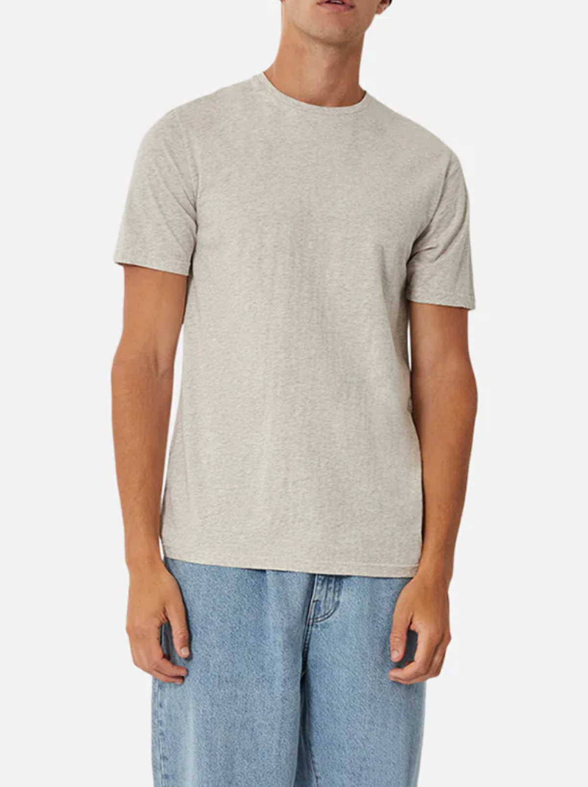 A person wears an Industrie The Basic Crew Tee in light gray paired with blue jeans, both everyday staples, and stands against a white background. Only their upper body and legs are visible, facing forward.