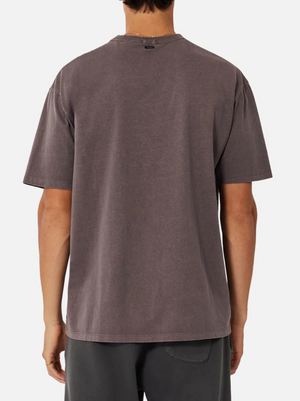 A person is shown from the back wearing an oversized Industrie The Del Sur Tee and dark shorts against a plain white background.