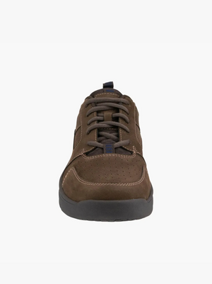 The Florsheim Mac Mocc Ox Lace sneakers feature brown lace-up styling with a black sole and intricate stitching. Set against a white background, these shoes incorporate KORE technology for comfort, viewed from the front angle.