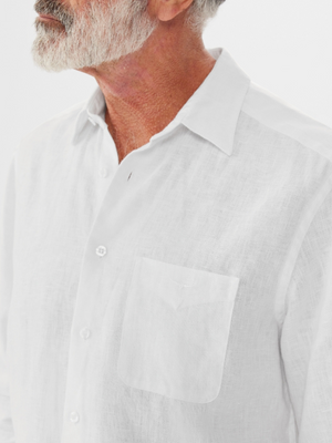 An elderly man with a white beard wears an RM Williams Coalcliff Shirt, crafted from 100% linen with a front pocket and buttons. The image captures him shoulder-up against a plain background.