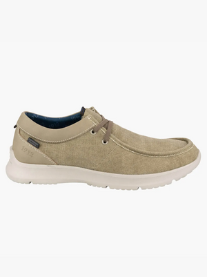 The Florsheim Bushwacker Canvas Slip On is a light beige casual shoe with a woven texture, brown laces, memory foam insole for comfort, white cushioned sole, and subtle stitching details.