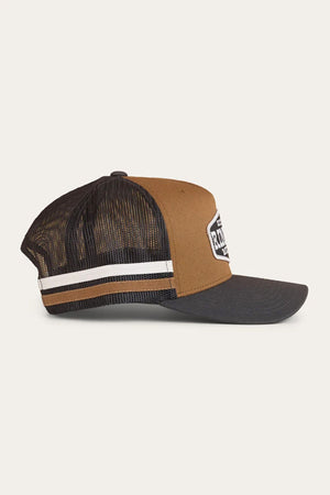 The Ringers Western Banks Trucker Cap features brown and black panels, a mesh back, white and brown side stripes, a black brim, a front white patch with text, and an adjustable snapback for comfort.