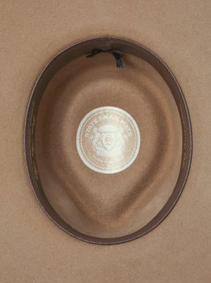 Inside view of the Statesman Big Australian Fur Felt Hat with a leather band features a central sticker with an emblem and the text "STATESMAN HATS" and "FINE FUR," showcasing the superior rabbit fur felt craftsmanship.