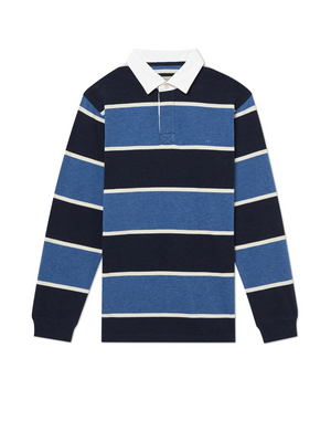 The RM Williams Tweedale Rugby is a long-sleeved heavyweight jersey knit rugby shirt with navy, blue, and white horizontal stripes. It features a white collar and a small longhorn embroidery on the left chest, displayed laid flat on a white background.