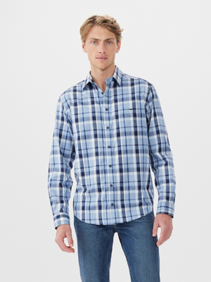 A person stands against a plain white background wearing an RM Williams Collins Shirt in blue and white plaid. This lightweight cotton twill shirt, with adjustable cuffs, pairs perfectly with classic jeans for a relaxed yet polished look.