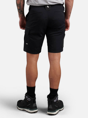 A person is shown from behind wearing King Gee Trademark Cargo Shorts in black and black athletic shoes, with a tattoo visible on their left arm, standing against a plain white background.
