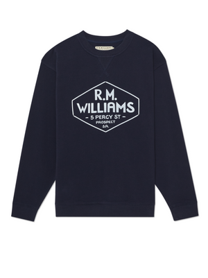 The RM Williams Gladstone Crew Neck is a navy blue cotton fleece sweatshirt with a relaxed fit and features a hexagonal graphic displaying "5 Percy St, Prospect SA" in white.