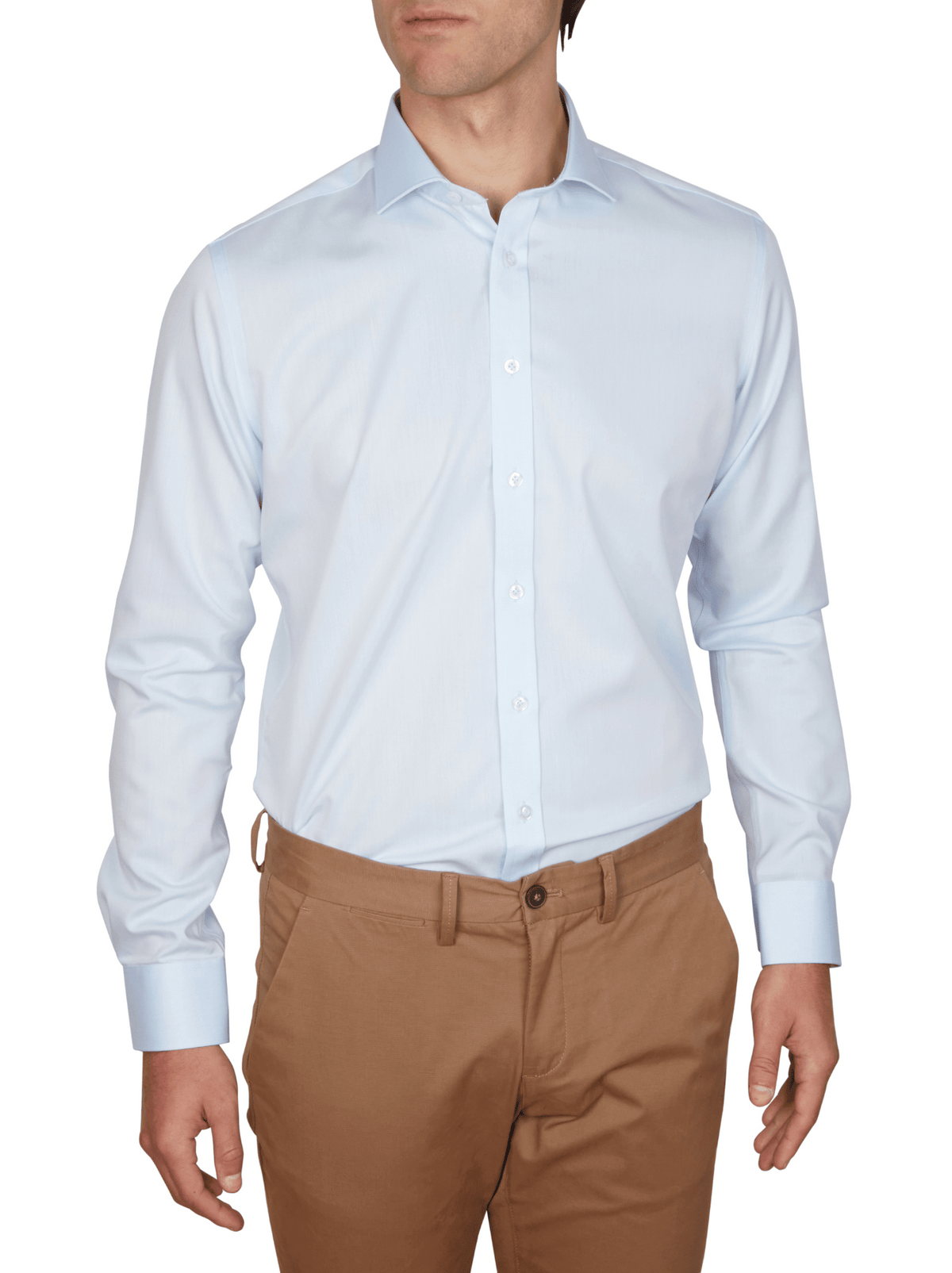 A man wears the Abelard Non Iron Cotton Twill Slim Fit Shirt in light blue with a cutaway collar and light brown pants, standing relaxed with arms at his sides and facing forward. The image is cropped just above his head.