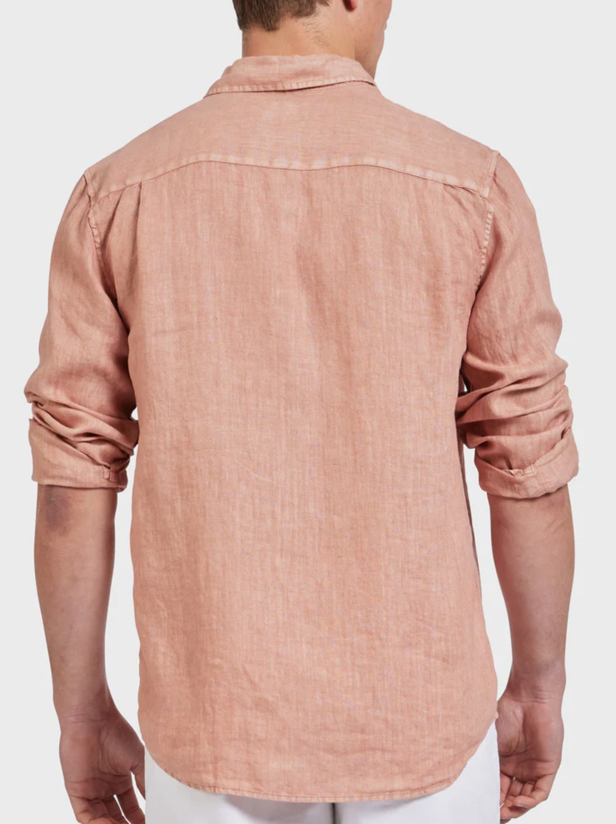 A person wears the Academy Brand Hampton Linen Shirt in light pink with long, rolled sleeves, shown from the back against a plain white background.
