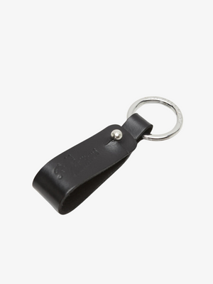 The RM Williams Pioneer Key Fob is a black leather key fob with a loop design, attached to a sleek silver metal ring. Made from double butt leather with nickel hardware and subtle embossed text, it exudes understated elegance against a plain white background.