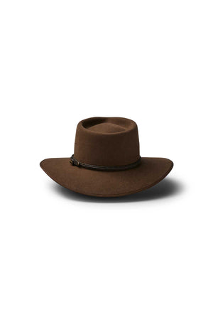 The Akubra Cattleman is a brown wide-brimmed hat with a flat crown and thin dark braided band, ideal for outdoor adventurers seeking rugged style. Shown against a white background.