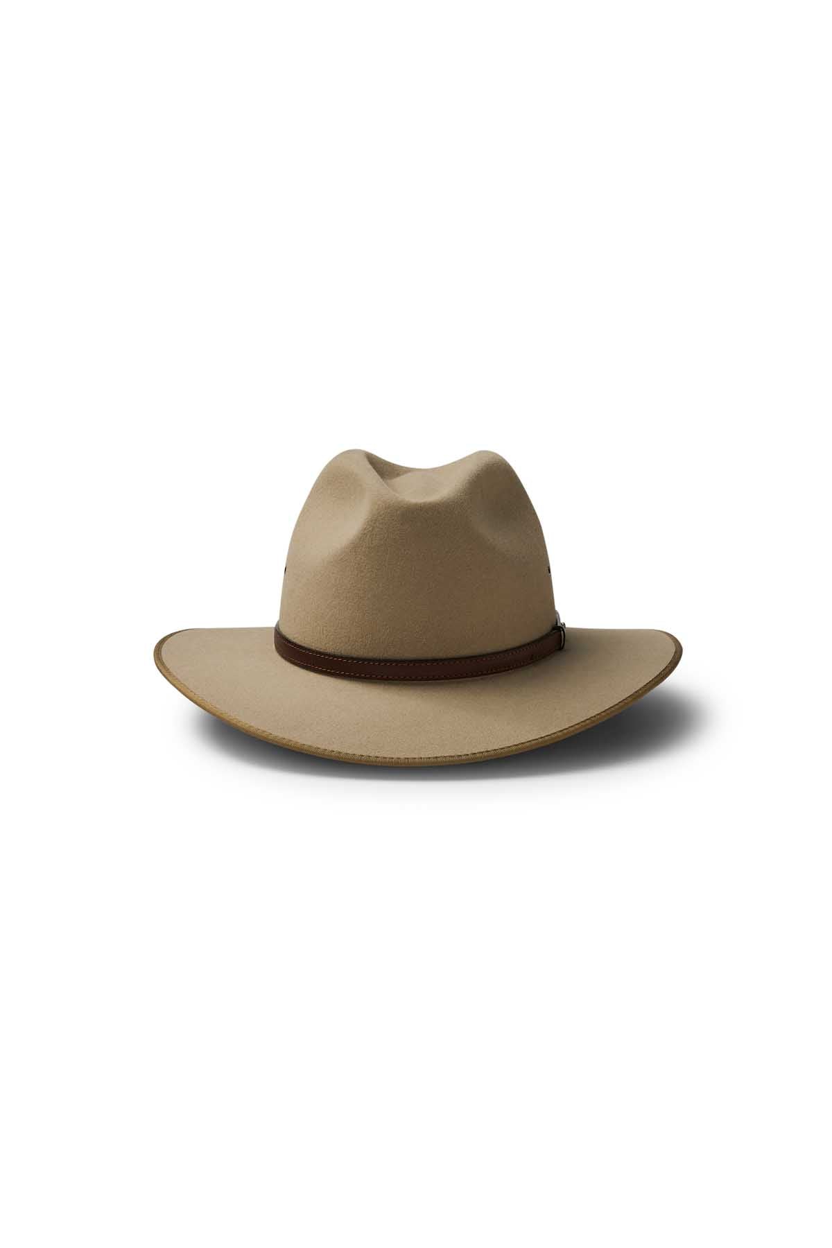 The Akubra Coober Pedy is a beige wide-brimmed cowboy hat with a brown band, shown against a white background with a soft shadow—ideal for embracing Australian style.