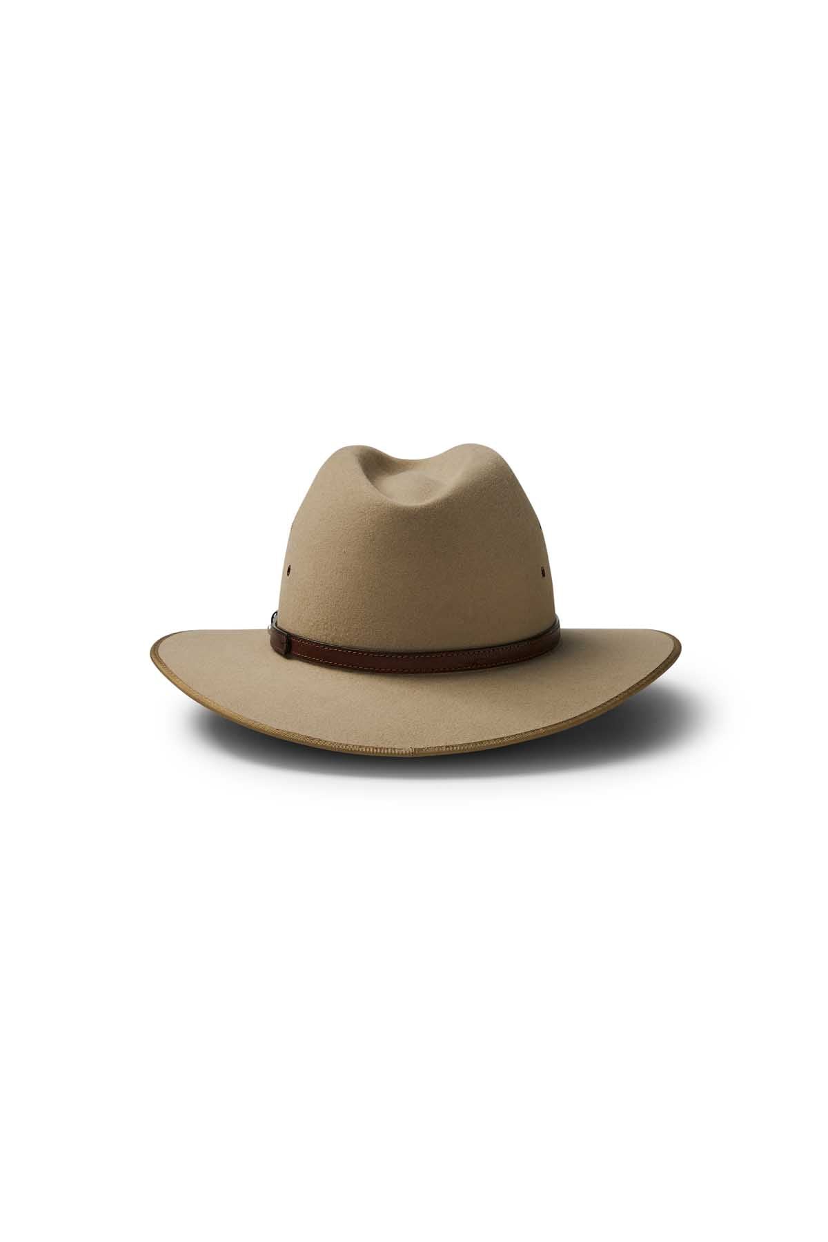 The Akubra Coober Pedy: a tan wide-brimmed hat with a creased crown and dark brown band, showcased on a white background—an iconic Australian style statement.