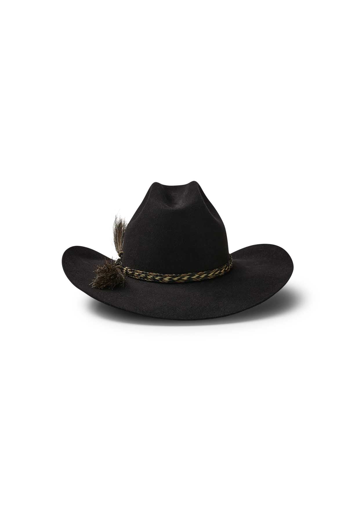 A black Akubra Rough Rider hat with a Cattleman crown, featuring a brown braided band and a small feather on the left side, set against a white background.