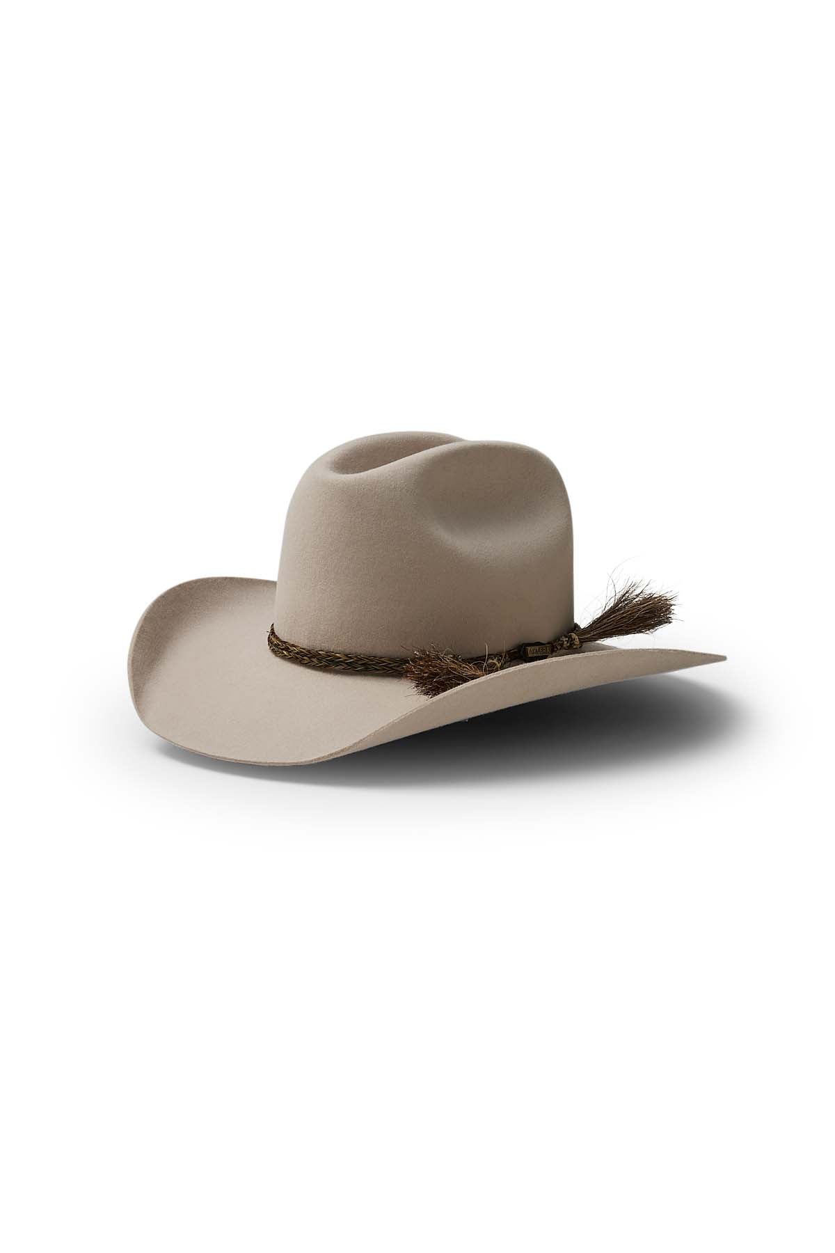 The Akubra Rough Rider is a light beige cowboy hat with a wide brim and braided brown band featuring a tassel, displayed on a white background—an iconic and durable choice for adventures.