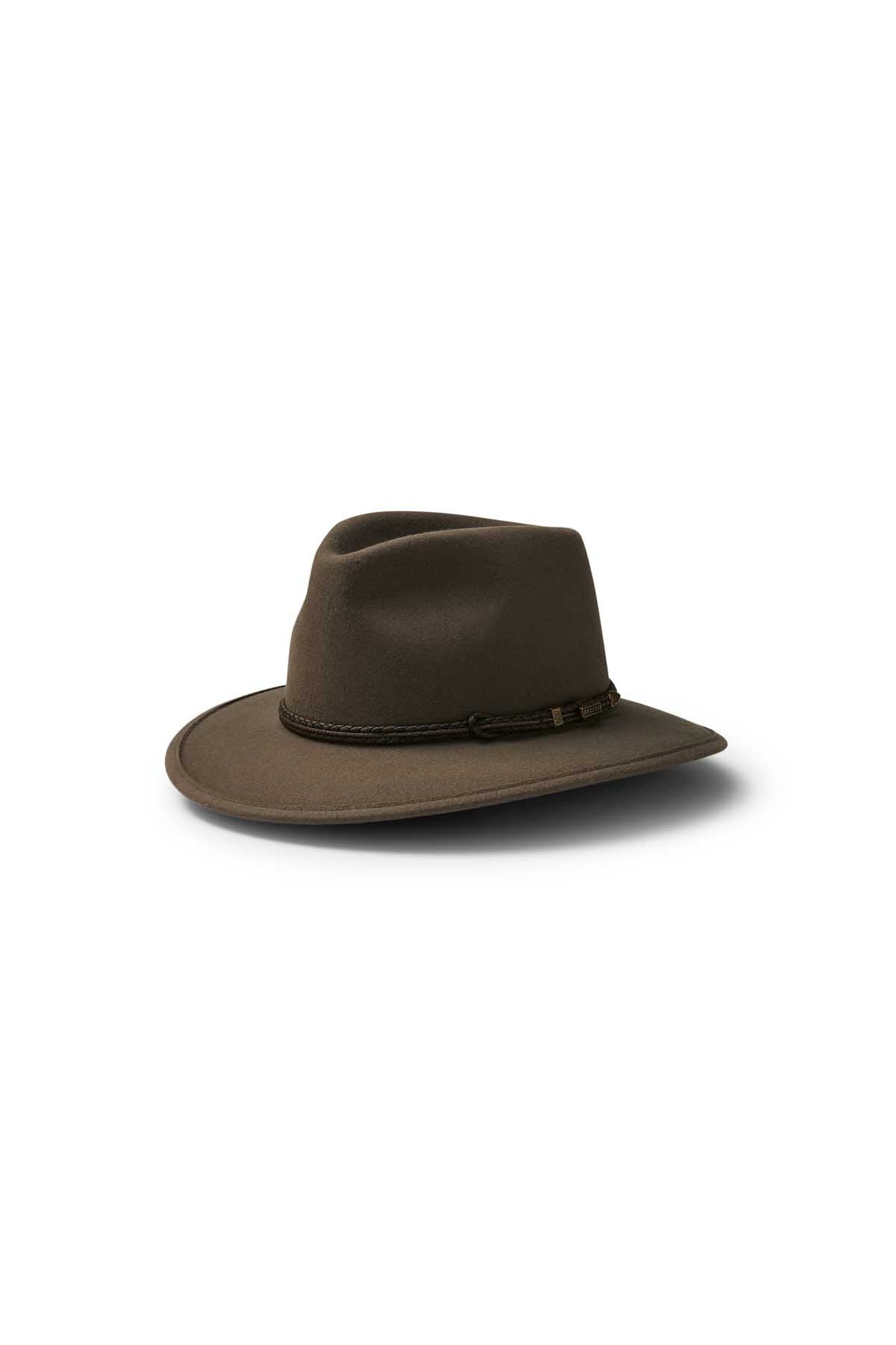 The Akubra Traveller, a brown wide-brimmed hat with a braided band and classic felt design, rests on a white background and casts a subtle shadow.