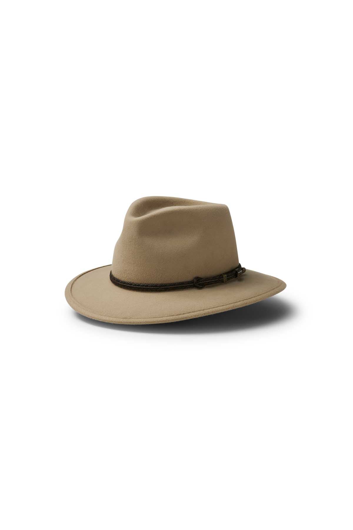 The Akubra Traveller is a wide-brimmed, light brown felt hat featuring a dark brown braided band and classic design, displayed on a white background with a soft shadow.