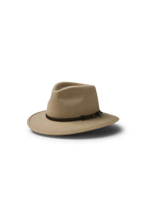 The Akubra Traveller is a wide-brimmed, light brown felt hat featuring a dark brown braided band and classic design, displayed on a white background with a soft shadow.