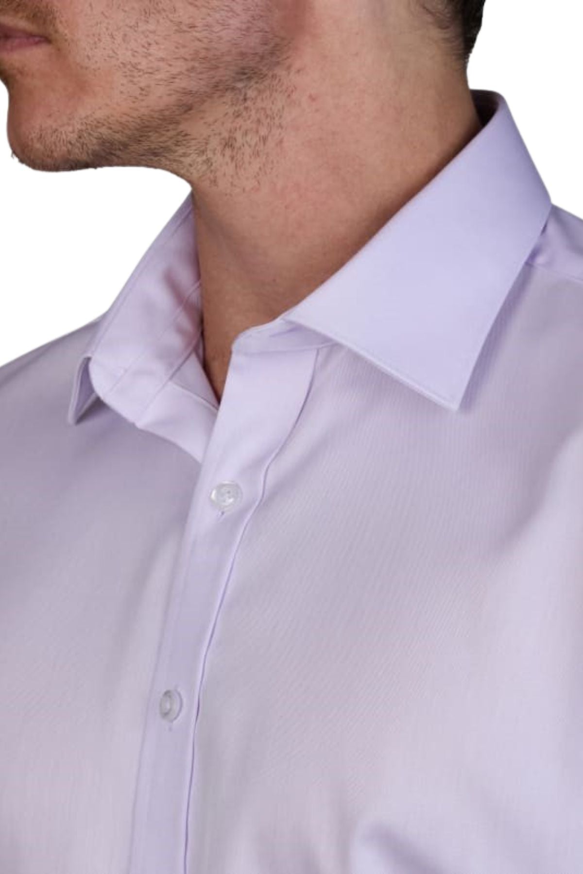 Close-up of a man in the Abelard Non Iron Cotton Twill Slim Fit Shirt, light lavender with a pointed collar. The shirt is buttoned up to show two white buttons, and the image highlights part of his clean-shaven face and neck stubble.