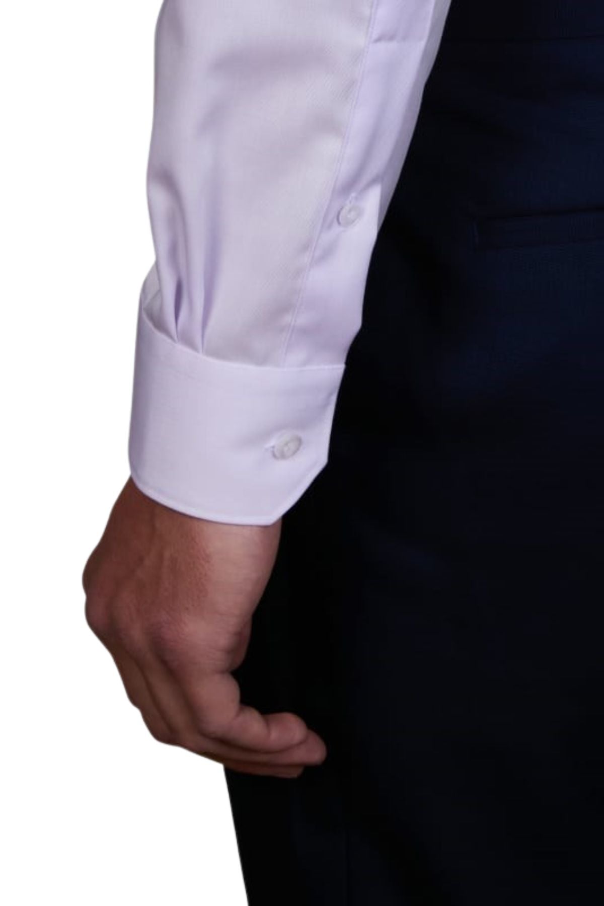A person wearing the Abelard Non Iron Cotton Twill Slim Fit Shirt in white with buttoned cuffs and dark pants, showing only their arm and hand at their side against a plain background.