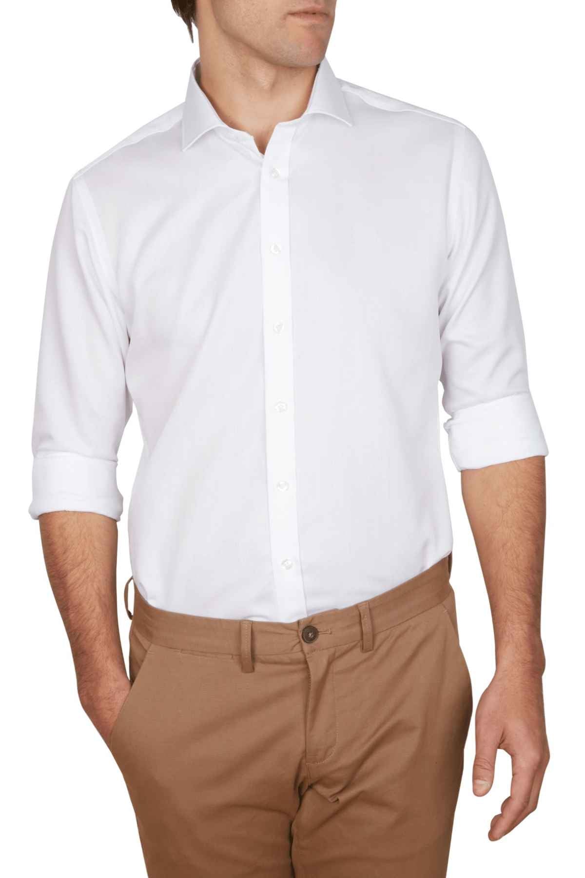 A person sports an Abelard Non Iron Cotton Twill Super Slim Fit Shirt with rolled-up sleeves and beige pants. The hand rests casually in the pocket, while the face stays unseen.