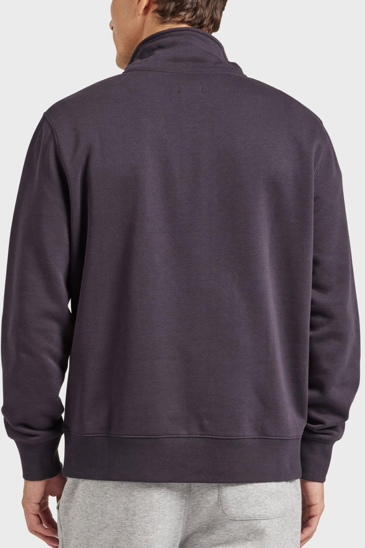 A man is seen from behind wearing the Academy Brand 1/2 Zip Sweat in dark purple premium brushed fleece and light gray sweatpants, standing against a plain light background.