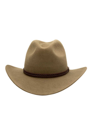 The Akubra Kiandra is a tan brown cowboy hat with a wide brim and a braided leather band around the base of the crown. Made in Australia from rabbit fur felt, this hat has a slightly creased top and boasts a smooth, felt-like texture.