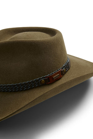 An Akubra Snowy River hat, brown wide-brimmed felt with a braided leather band and small metal side label, displayed on a white background.