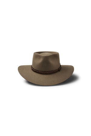 Akubra The Brumby: A brown wide-brim hat with a dented crown and braided dark brown band, shown on a white background with shadow—ideal for any Australian outback adventure or bush festival.
