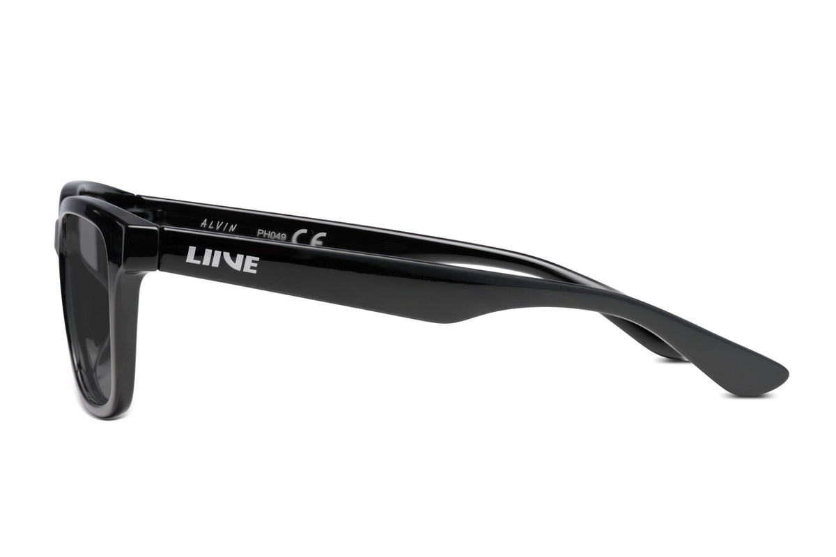 Side view of children's-sized black Liive Alvin sunglasses with a glossy finish. The frames have thick arms with "LIVNE" and model text in white, providing UV protection. These stylish shades are perfect for kids on sunny days.