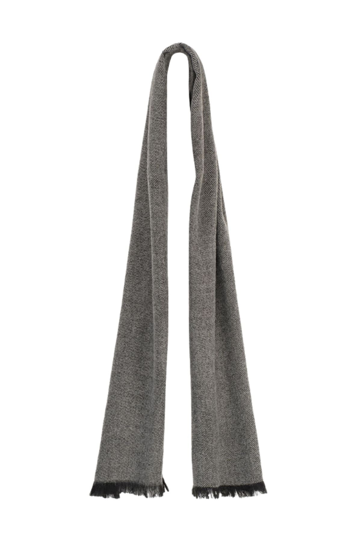 The Avenel River Two Tone Brushed Scarf is a long, grey accessory with a subtle pattern and short black fringes at each end, offering an elegant finish.
