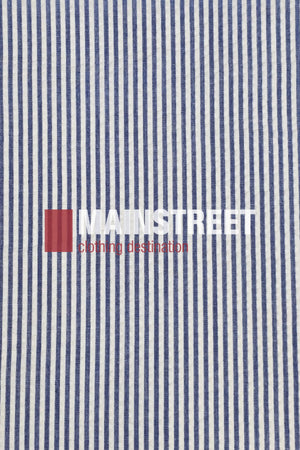 Blue and white vertical striped fabric background with "MAINSTREET" in bold white text and "clothing destination" in smaller red text over a red square, inspired by the Bisley Countryman Seersucker Short Sleeve Shirt.