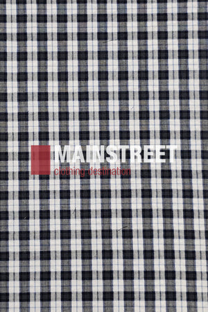 A black and white plaid fabric background displays "MAINSTREET clothing destination" in bold white and red text, evoking the timeless style of the Bisley Countryman Seersucker Short Sleeve Shirt.