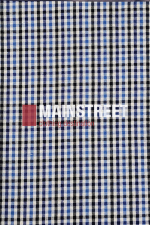 A black, blue, and white checkered fabric background with the "MAINSTREET clothing destination" logo in white and red evokes the classic style of the Bisley Countryman Seersucker Short Sleeve Shirt.